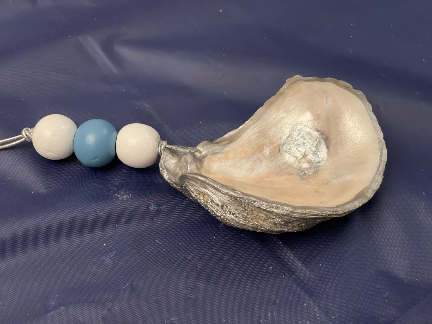 Hand painted blue trim oyster shell ornament