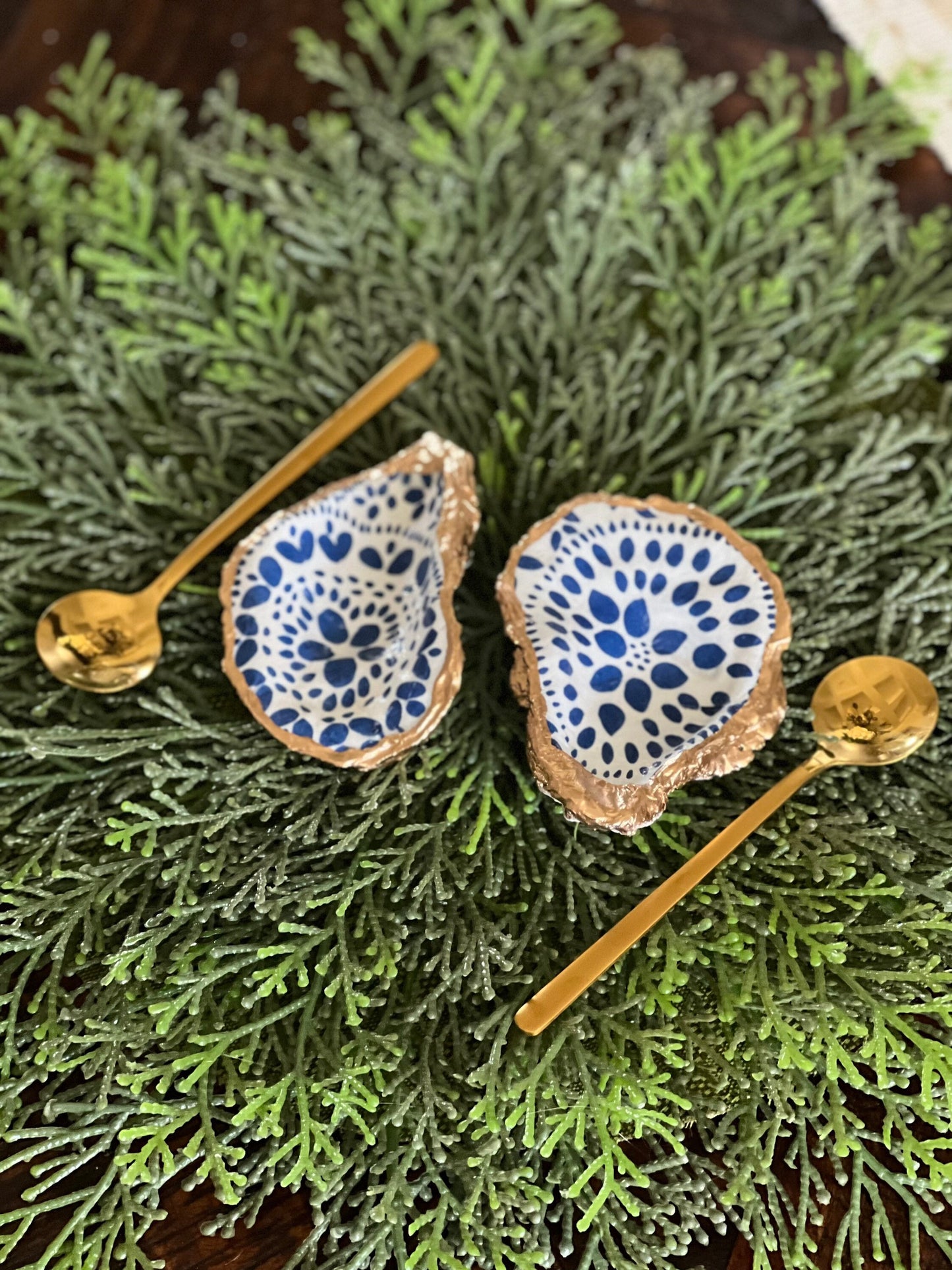 Gilded and decoupaged oyster shell salt/pepper dishes with spoons