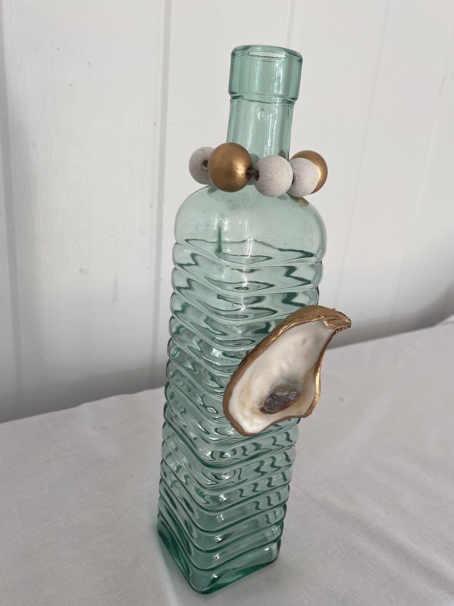 Decorative vase with gilded oyster accent