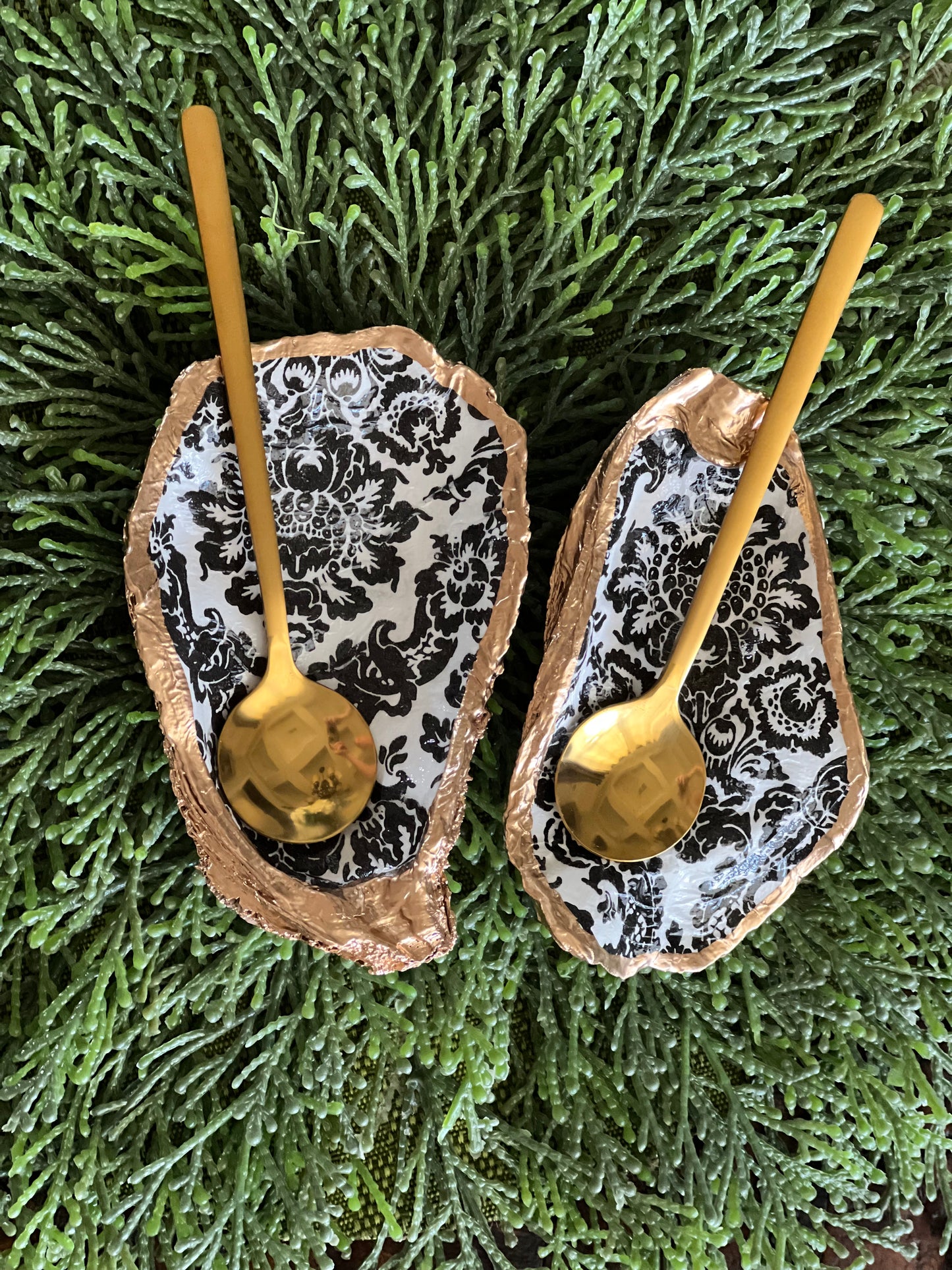 Gilded and decoupaged oyster shell salt/pepper dishes with spoons