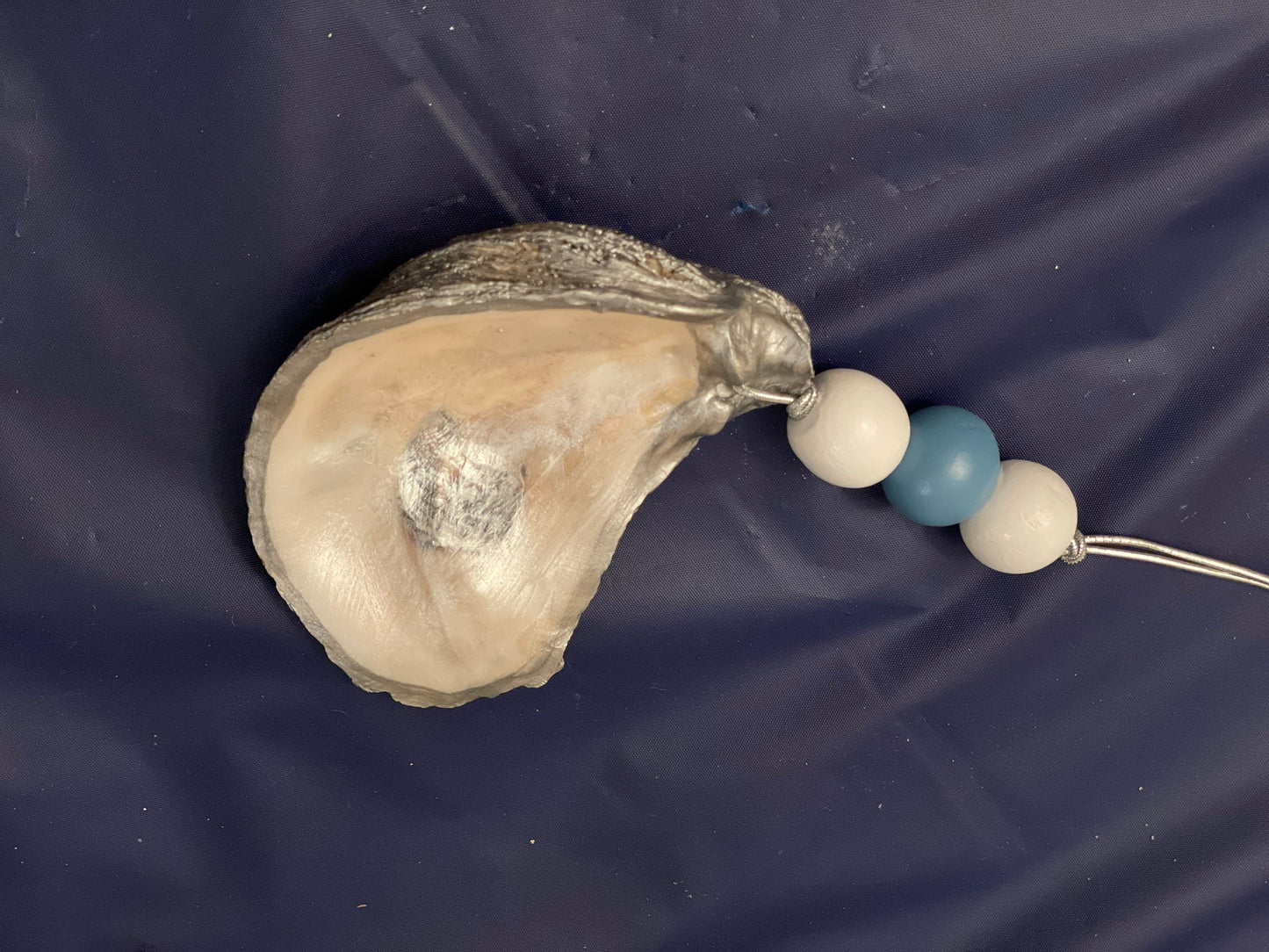 Hand painted blue trim oyster shell ornament