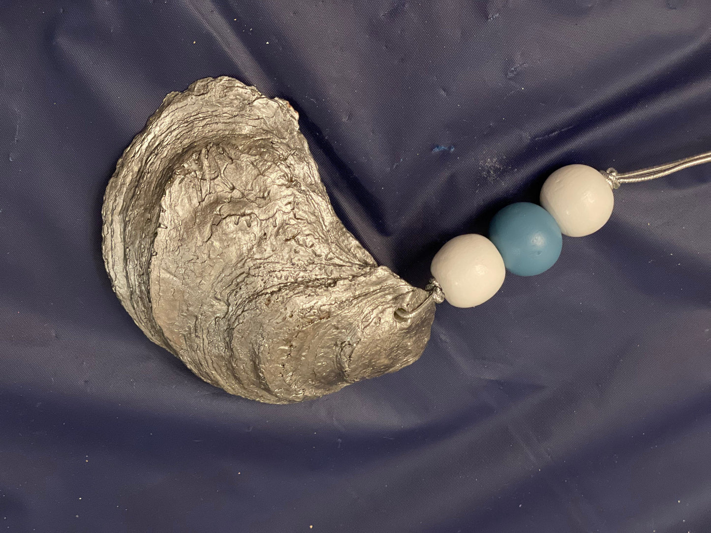 Hand painted blue trim oyster shell ornament