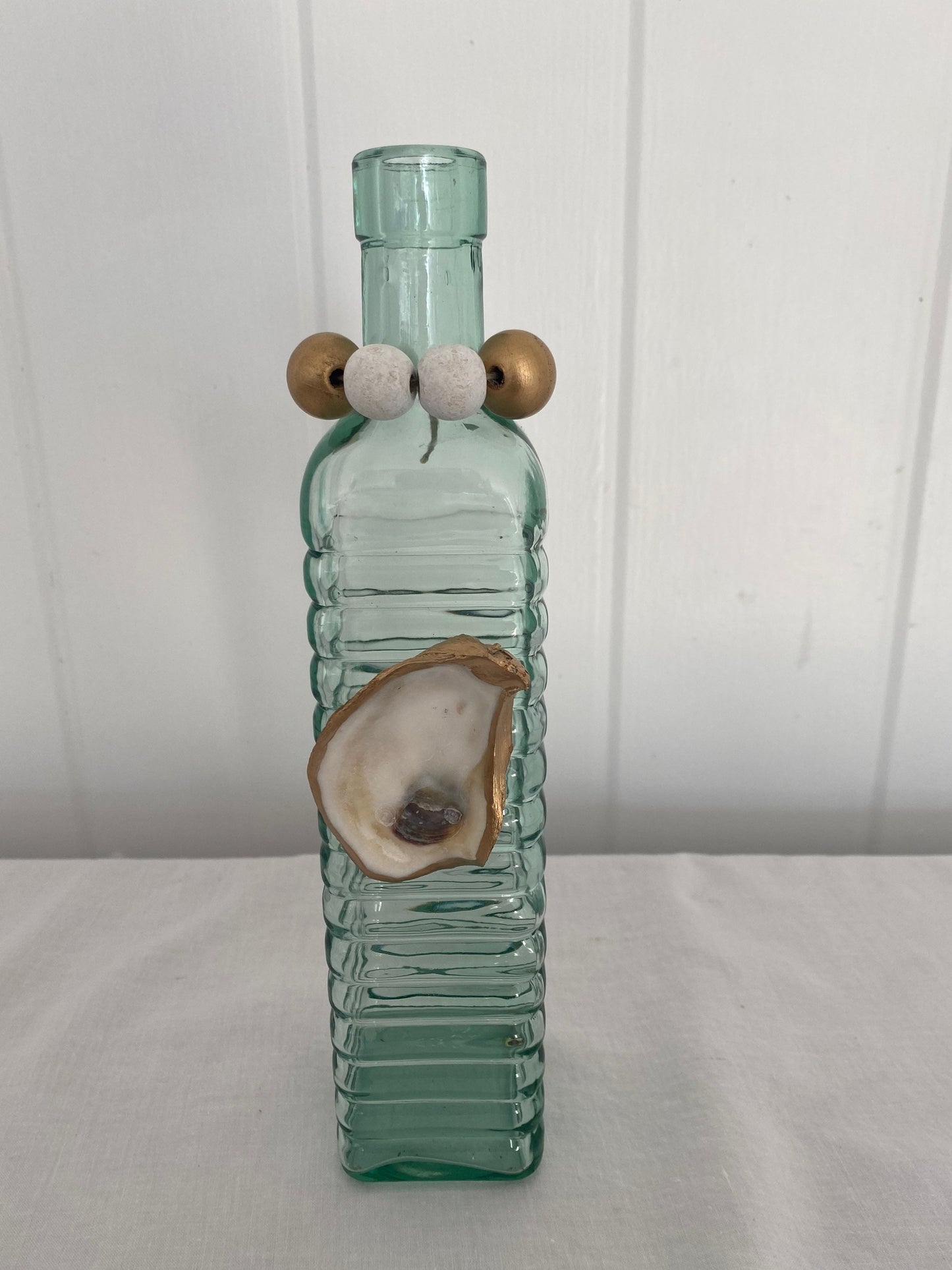 Decorative vase with gilded oyster accent