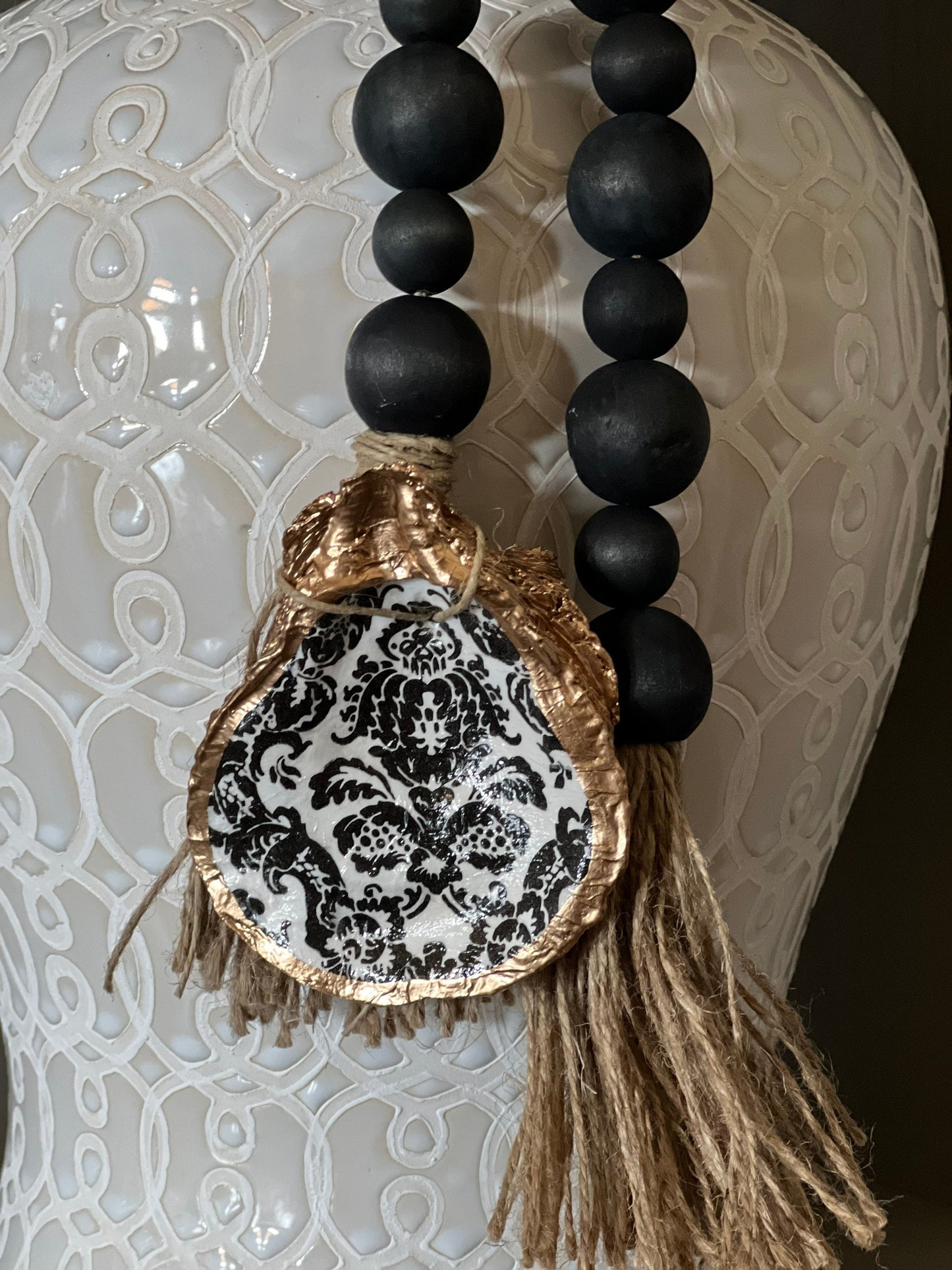 Decoupaged oyster shell prayer beads