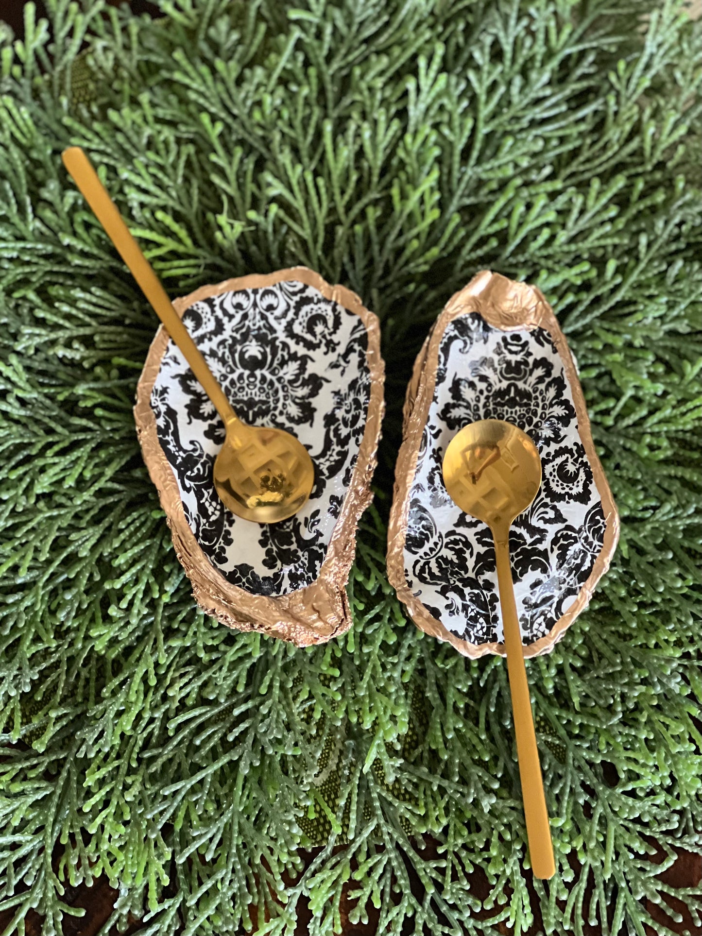 Gilded and decoupaged oyster shell salt/pepper dishes with spoons