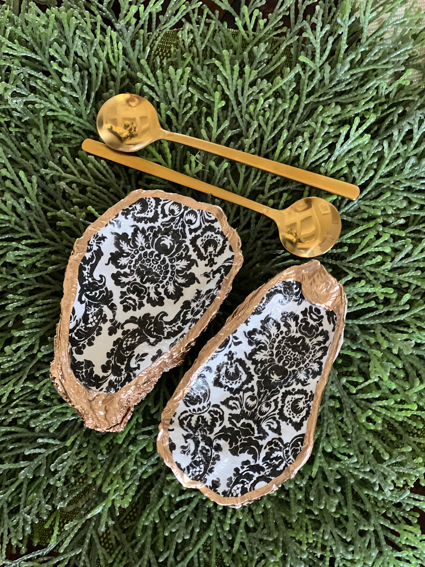 Gilded and decoupaged oyster shell salt/pepper dishes with spoons